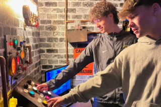 A group tries to solve the puzzle to exit the escape room at Max Missions.